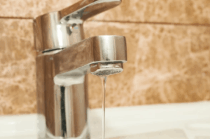 Image of a leaking faucet with water trickling