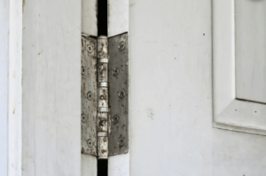 Image of slightly rusting door hinges in need of replacement